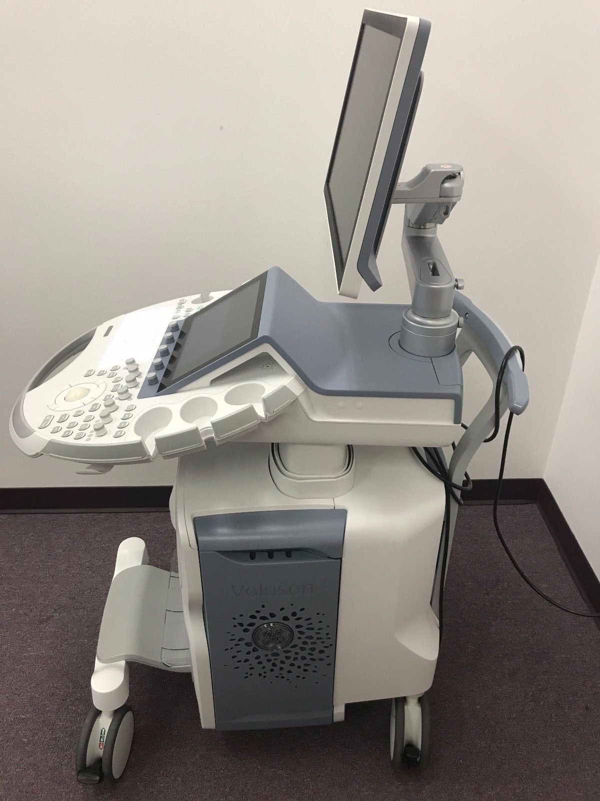 a medical machine with a monitor on top of it